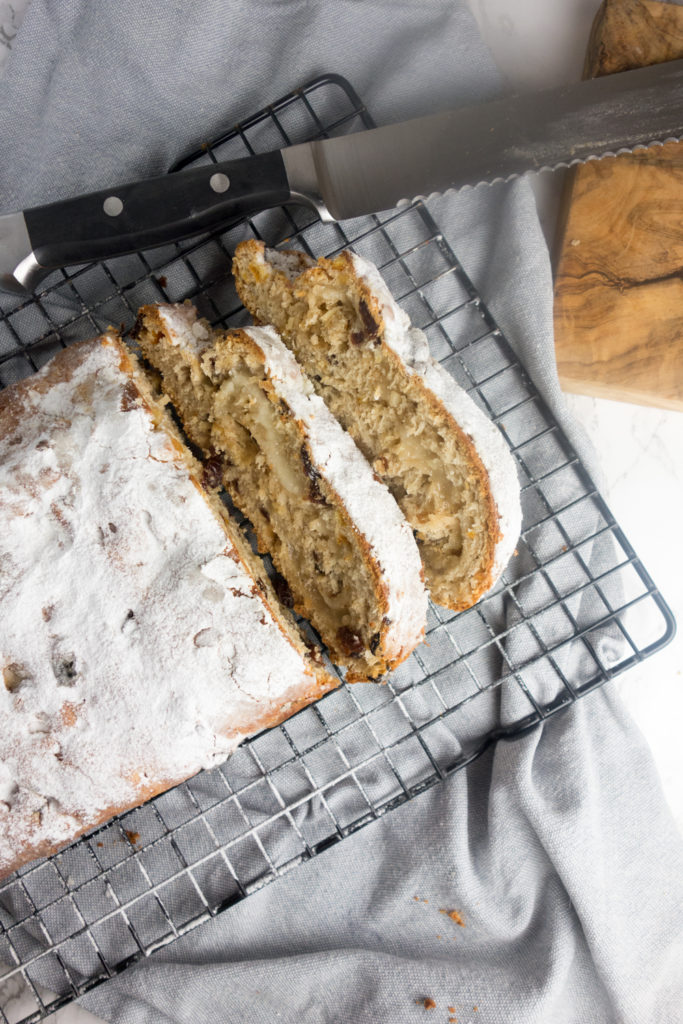 Homemade Christmas Stollen: A sweet bread enriched with butter, eggs, dried fruit and almonds, wrapped around marzipan and dusted with icing sugar!