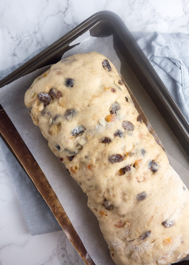 Homemade Christmas Stollen recipe: A sweet bread enriched with butter, eggs, dried fruit and almonds, wrapped around marzipan and dusted with icing sugar. SO good!