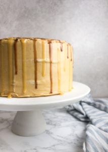 Snickers Birthday Cake recipe: Rich chocolate sponge filled with a thick layer of nougat and salted caramel, topped with creamy peanut butter frosting. Yum!