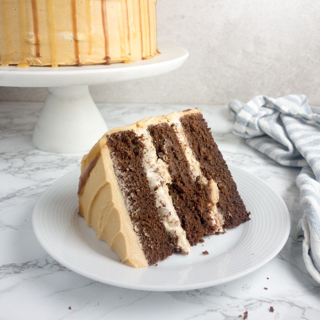 Snickers Birthday Cake recipe: Rich chocolate sponge filled with a thick layer of nougat and salted caramel, topped with creamy peanut butter frosting. Yum!