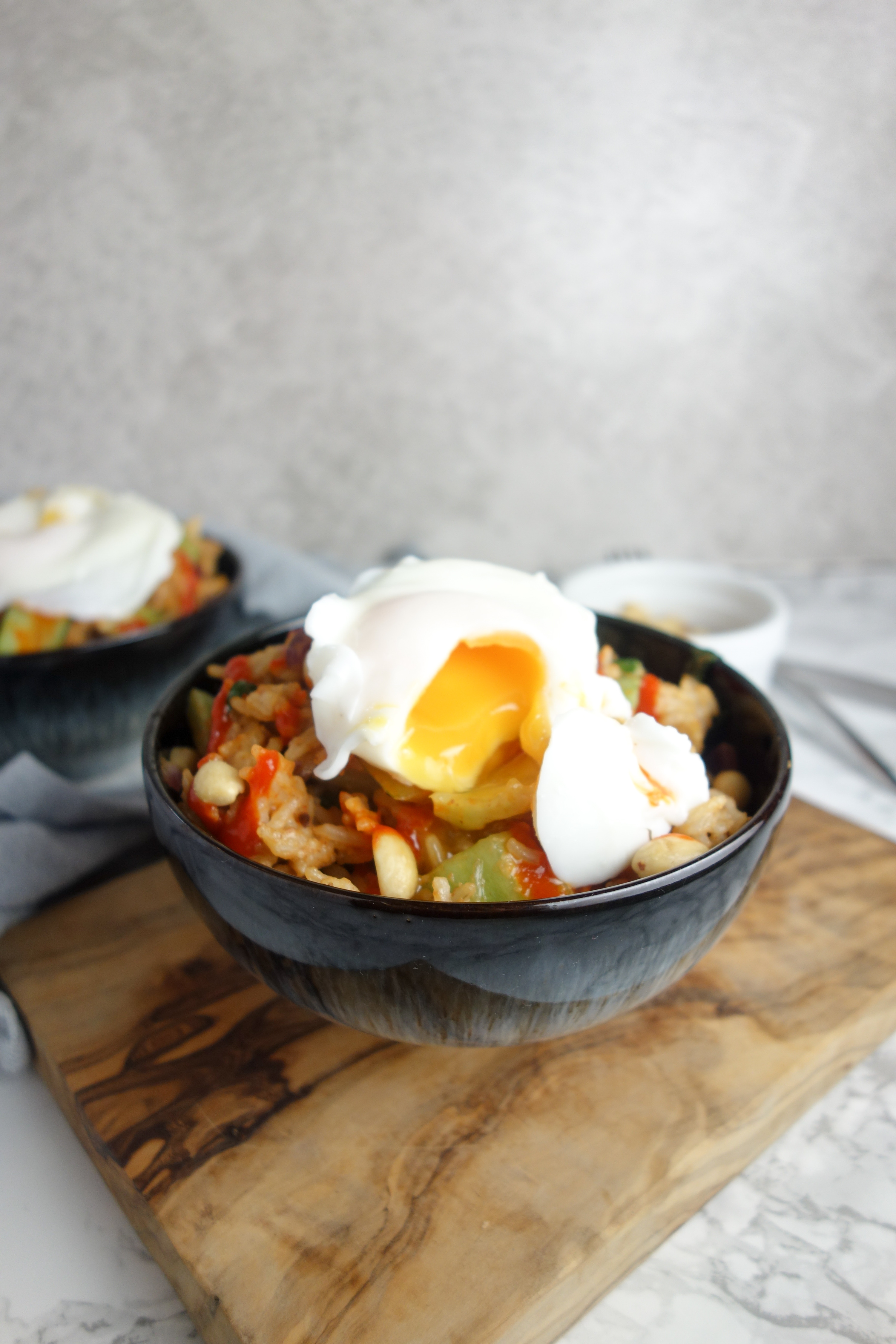 Rice & veg smothered in peanut butter, sriracha and soy sauce then topped with a perfectly poached egg - an easy recipe for spicy peanut rice!